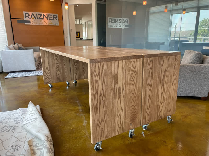 Two waterfall-edge ash tables on casters, built for a law firm's lobby