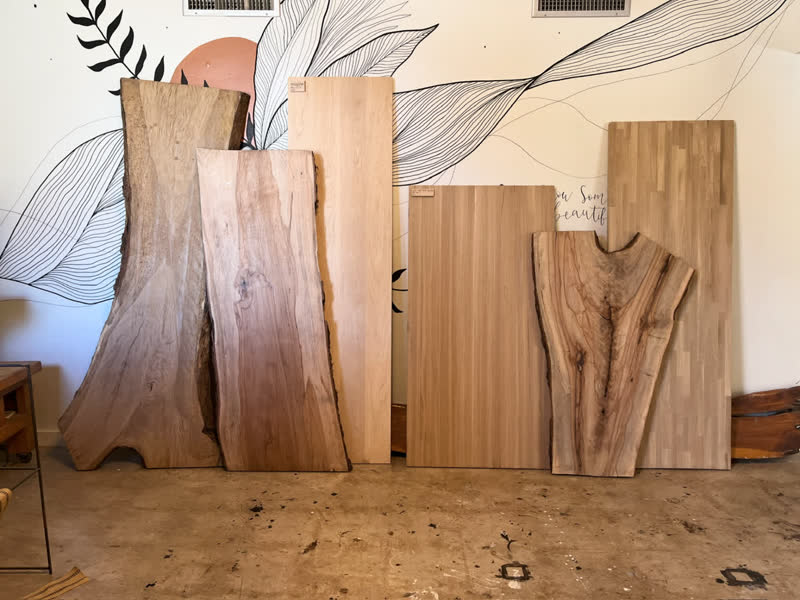 Hardwood slabs lined up in the shop waiting to become tables