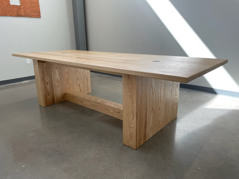 A light oak conference table with power grommets, built for a client's office